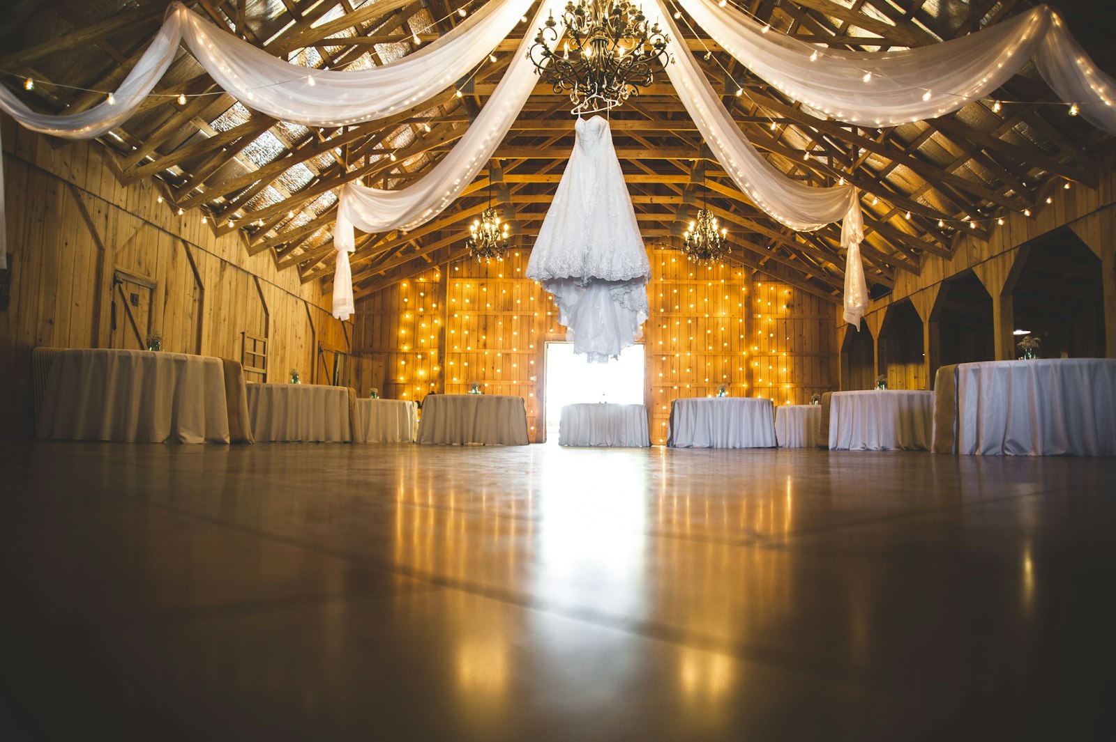 Barn reception with draped ceiling lights near Prince George