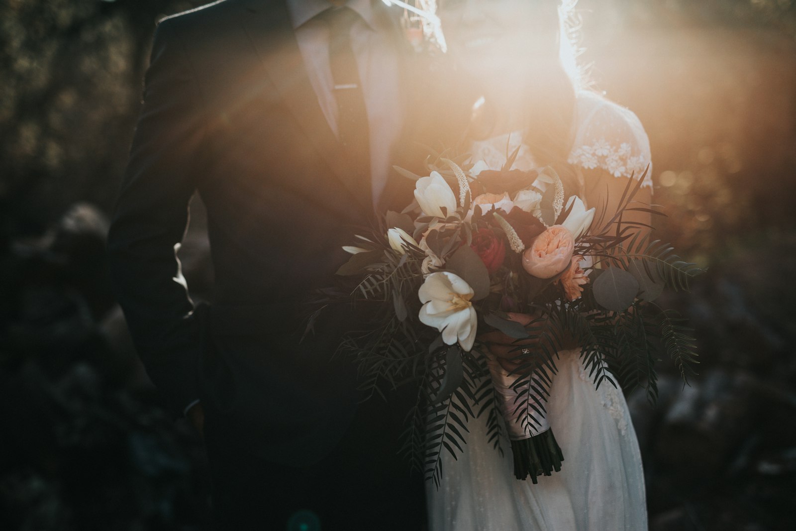 Bride holding her bouquet in soft window light