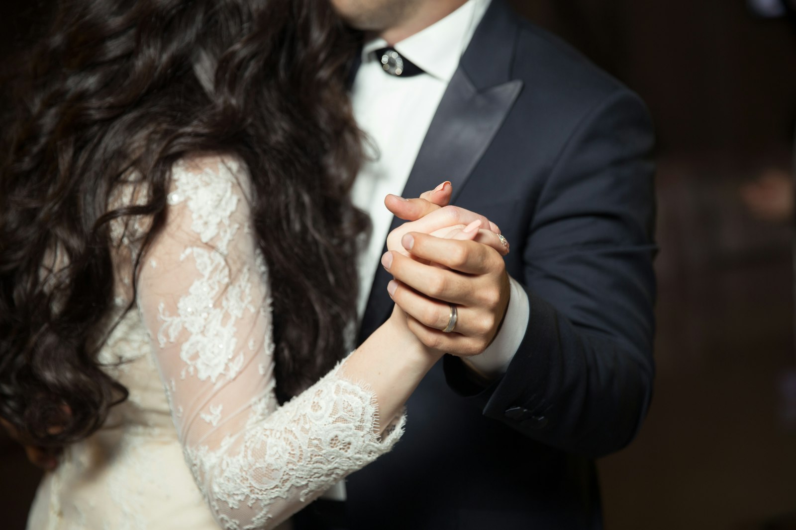 Close-up of a couple's hands during their first dance