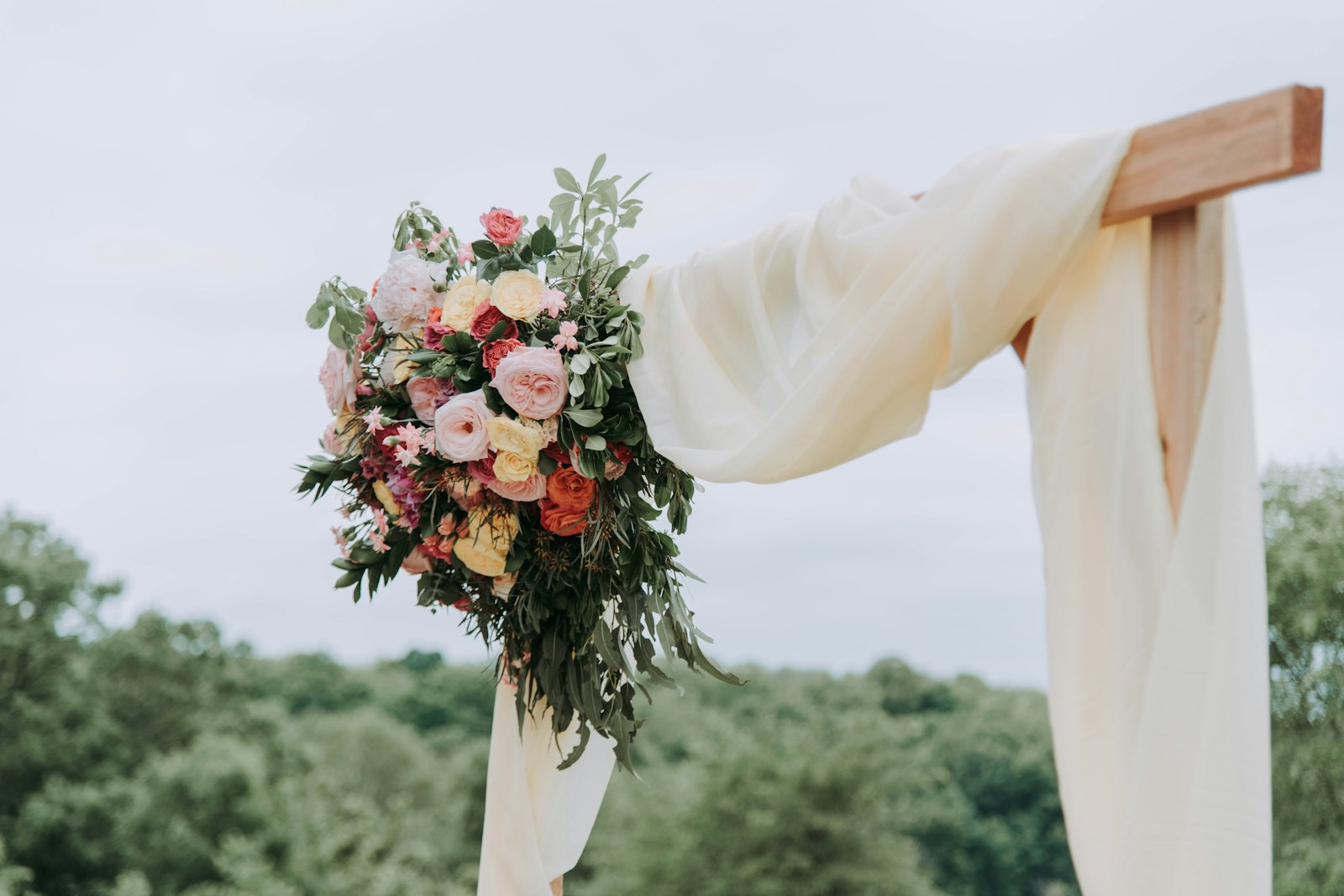 Floral ceremony arch at an outdoor wedding near Dawson Creek
